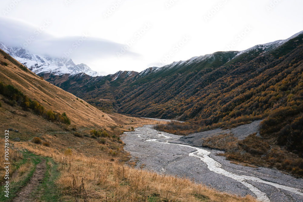Meandering River Through Autumnal Mountain Valleys Under the Approaching Dusk