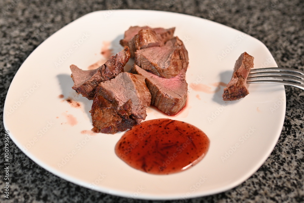 veal steak roasted medium rare in used dishes with red sauce veal steak roasted medium rare in used dishes with red sauce