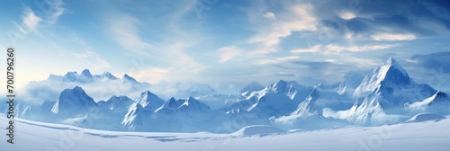 Panoramic landscape of high mountain range in winter with snowy peaks with ice and clouds