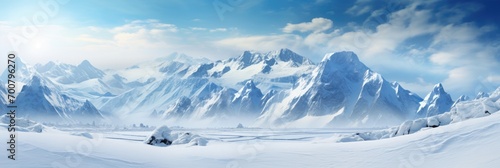 Panoramic landscape of high mountain range in winter with snowy peaks with ice and clouds © Barosanu