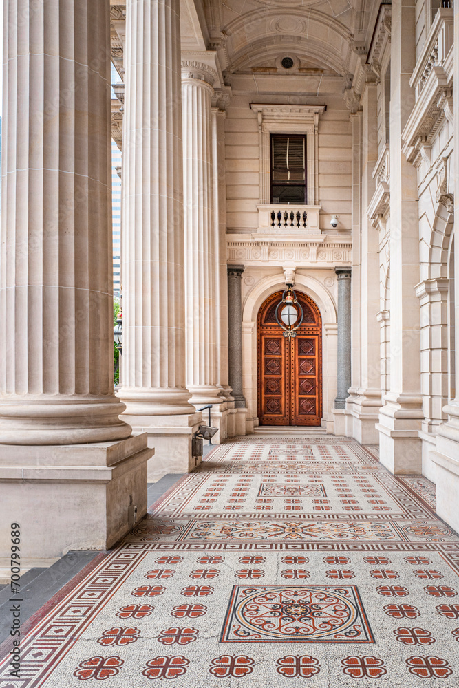 Fototapeta premium Wood Gate in the Parliament House is the meeting place of the Parliament of Victoria, its grand colonnaded front dominates the vista up Bourke Street. Melbourne, Australia, Dec 2019