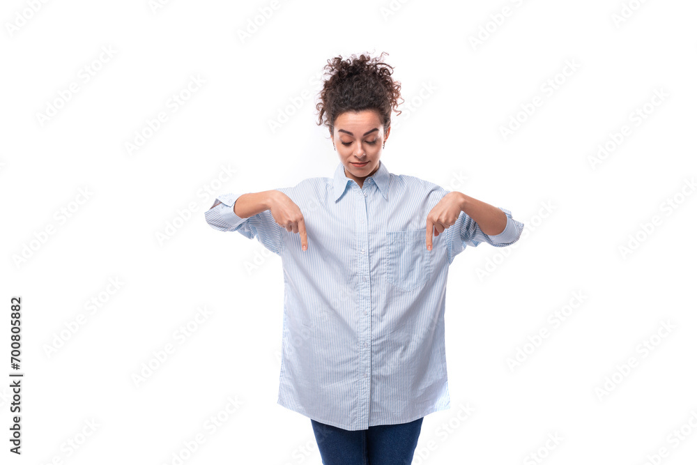 young fashion woman caucasian woman with curly black hair gathered in a ponytail wears a blue shirt young fashion woman caucasian woman with curly black hair gathered in a ponytail wears a blue shirt
