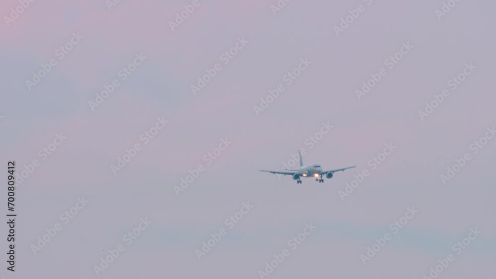 Passenger jet airplane approaching landing over the city at Adler airport, Sochi Passenger jet airplane approaching landing over the city at Adler airport, Sochi