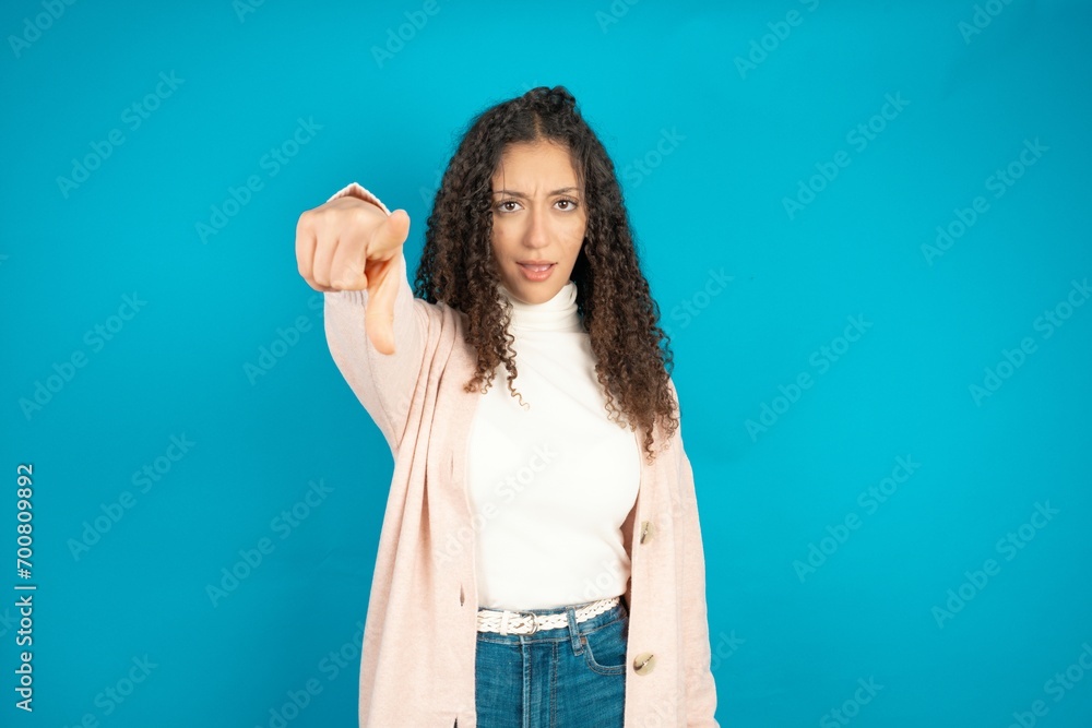 beautiful teen girl pointing displeased and frustrated to the camera, angry and furious ready to fight with you. beautiful teen girl pointing displeased and frustrated to the camera, angry and furious ready to fight with you.