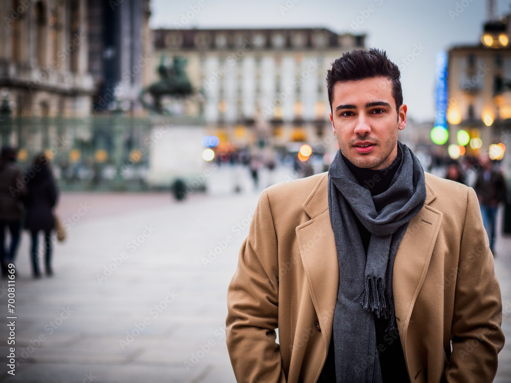 Photo of a stylish man posing in front of a striking architecture Photo of a stylish man posing in front of a striking architecture