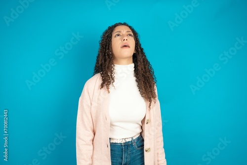 Beautibul teen girl wearing casual clothes angry and mad screaming frustrated and furious, shouting with anger. Rage and aggressive concept. photo