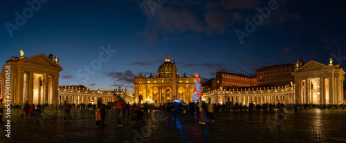 night view of St. Peter's Basilica illuminated and crowded with busy people