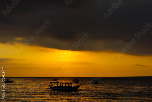 Silhouette view of traditional boats in the beach during sunset. Nipah beach  West Nusa Tenggara  Indonesian tourism object
