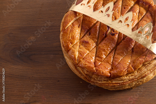 Epiphany cake on wooden table. Galette des rois traditional Epiphany cake in France photo
