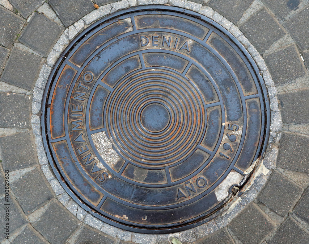 Vintage retro metal sewer manhole, close-up, Spain, Denia