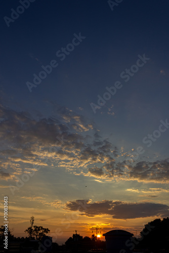 Wallpaper Mural Sunset over the city with clouds in the blue sky background. Torontodigital.ca