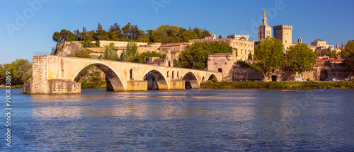 Famous medieval Saint Benezet bridge and Palace of the Popes during gold hour, Avignon, France photo