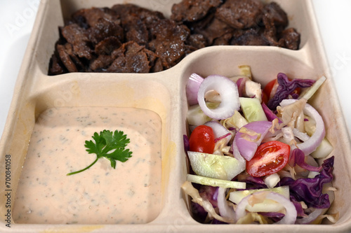 biodegradable lunch tray with roast meat salad herb sauce healthy food protein