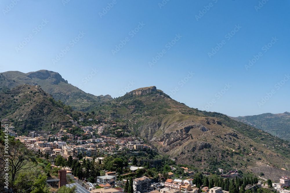 Aerial view of old town of Taormina in sunny day from ancient greek theatre, Sicily, Italy