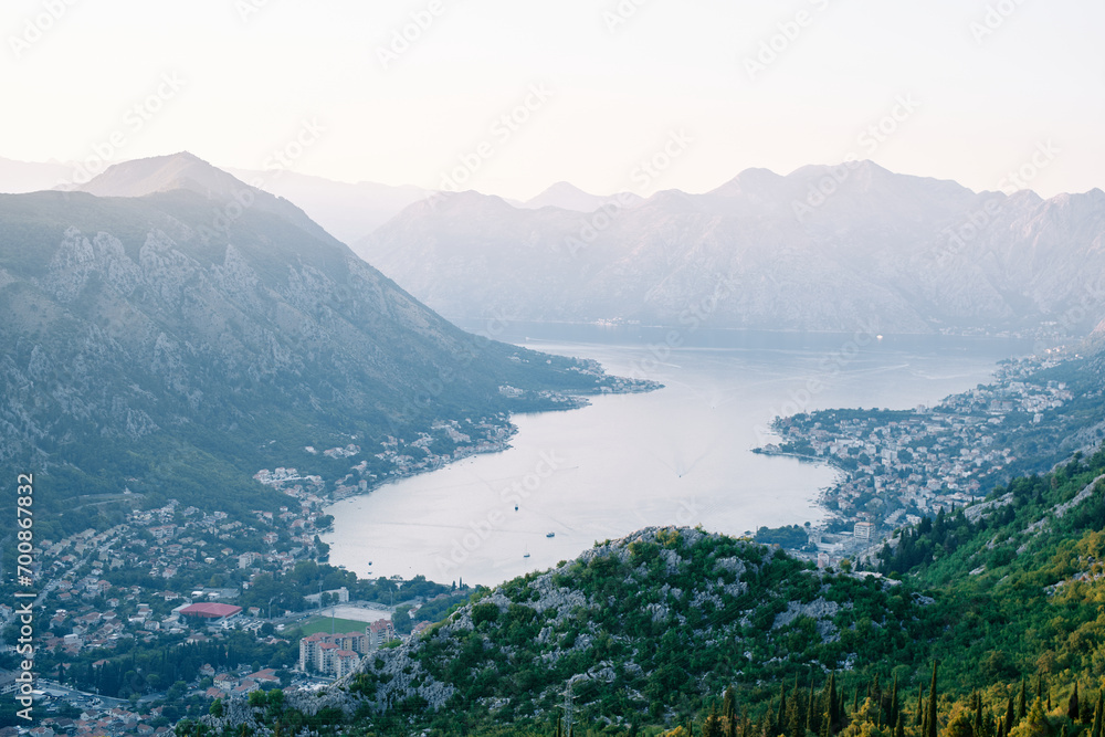 Resort towns on the coast in the valley of the Bay of Kotor, surrounded by mountains. Montenegro. Top view