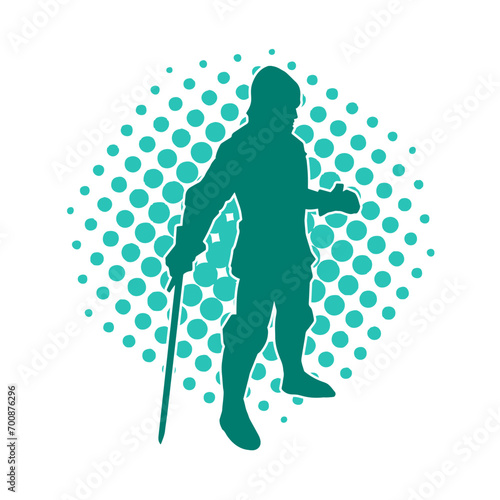Silhouette of a male warrior wearing war armor suit in action pose using a sword weapon.