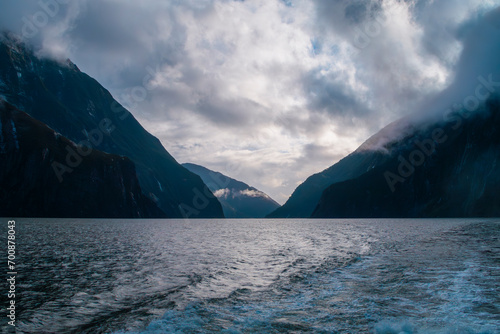 Photograph of low hanging clouds over mountains in Milford Sound in Fiordland National Park on the South Island of New Zealand