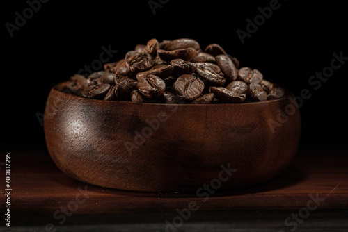 Coffee Beans In Wooden Bowl Isolated On Black.