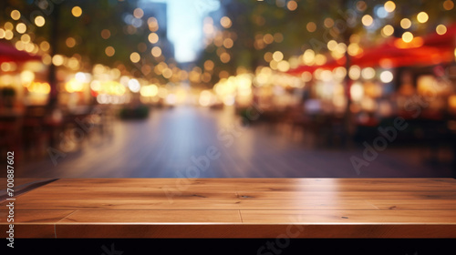Foreground focus on a polished wooden table with a blurred restaurant scene and sparkling bokeh lights in the background. © tashechka