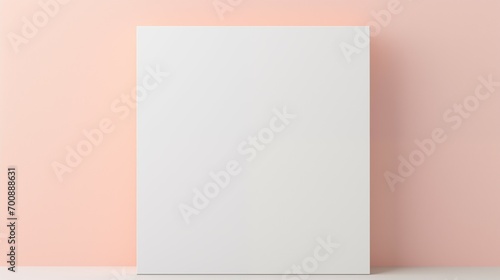Blank white book on peach background.