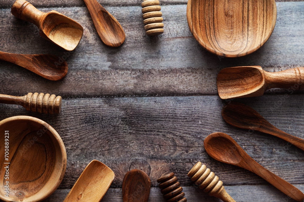 A top-down view of various types of wooden ladles and bowls placed on a ...