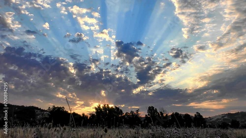 time-lapsed sunset clouds with dramatic rays of light in motion