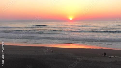 unrecognizable couple taking selfie photos of beautiful ocean waves beach sunset on Oregon coast
