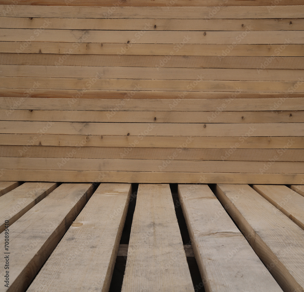Wooden boards, lumber, industrial wood, timber. Pine wood timber. Rough spruce and pine lumber pile at a sawmill. Pile of wooden boards at lumber production factory. beams, plank background. material Wooden boards, lumber, industrial wood, timber. Pine wood timber. Rough spruce and pine lumber pile at a sawmill. Pile of wooden boards at lumber production factory. beams, plank background. material