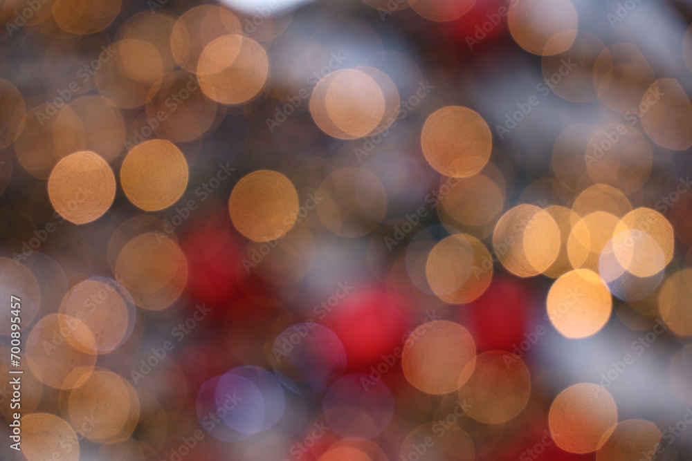 Obraz premium Many defocused bright lights and decorations on Christmas tree. Festive backdrop for your design. Background with garland illuminating lights and snow. Festive garland. symbol of Christmas New Year.
