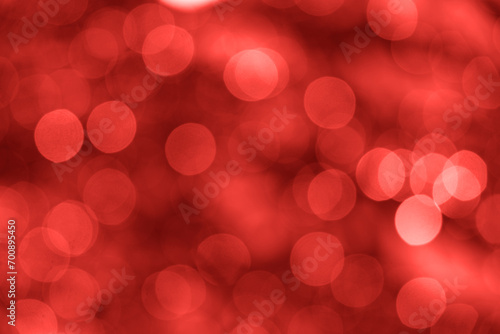 Many defocused bright lights and decorations on Christmas tree. Festive backdrop for your design. Background with garland illuminating lights and red. Festive garland. symbol of Christmas New Year.