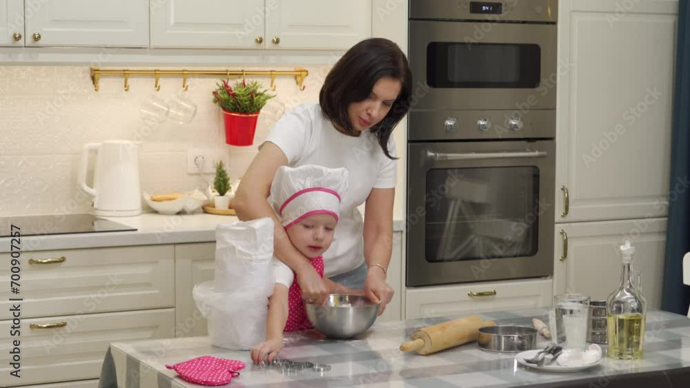 mother and 3-year-old child cooking together pastries, little boy and mom making cookie dough to bake Christmas gingerbread cookies mother and 3-year-old child cooking together pastries, little boy and mom making cookie dough to bake Christmas gingerbread cookies