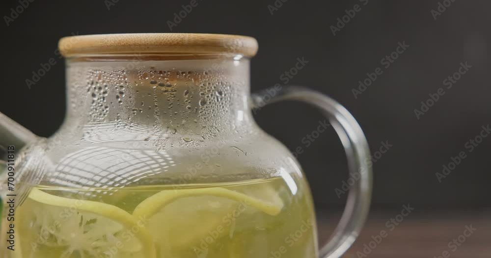 Steaming glass teapot with natural organic herbal tea with lemon and mint Steaming glass teapot with natural organic herbal tea with lemon and mint