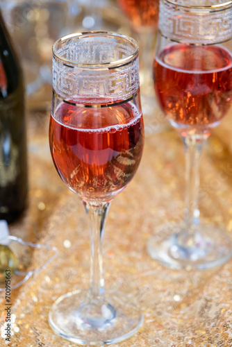 glasses of rose champagne on sparkling golden cloth