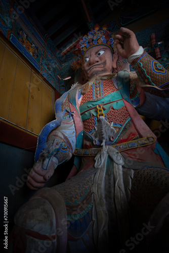 The colorful statue of a guard in Woljeongsa Temple is Located in a forested valley on the eastern side of Odaesan Mountain, South Korea. Korean traditional temple.