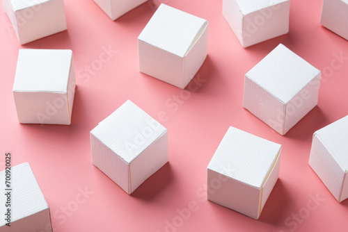 top view of colorful blank paper boxes on pink background. copy space available