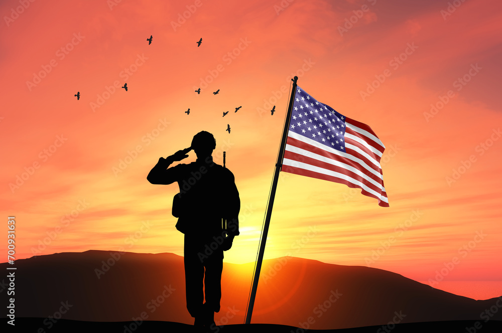 Silhouette of a soldier with the USA flag stands against the background of a sunset or sunrise. Concept of national holidays. Commemoration Day.
