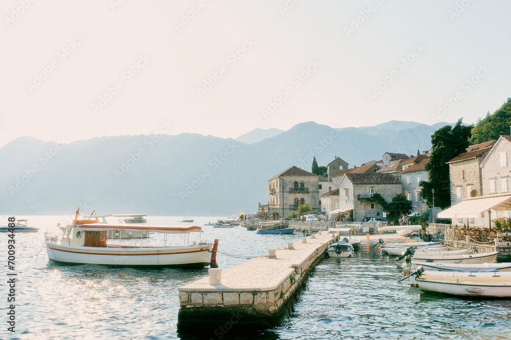 Fishing boats are moored in a row off the coast of Perast. Montenegro