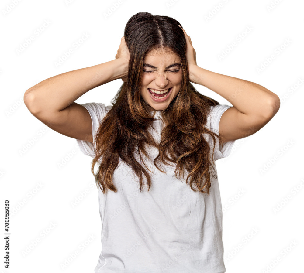 Young Caucasian woman in studio setting covering ears with hands trying not to hear too loud sound. Young Caucasian woman in studio setting covering ears with hands trying not to hear too loud sound.