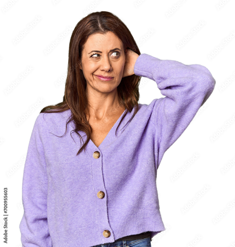 Elegant middle-aged Caucasian woman in studio setting touching back of head, thinking and making a choice. Elegant middle-aged Caucasian woman in studio setting touching back of head, thinking and making a choice.