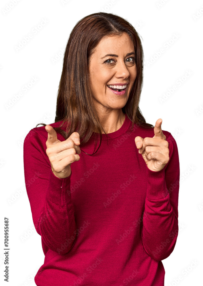 Elegant middle-aged Caucasian woman in studio setting pointing to front with fingers. Elegant middle-aged Caucasian woman in studio setting pointing to front with fingers.