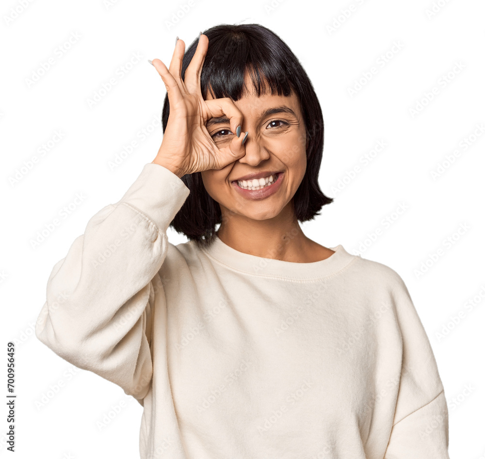 Young Hispanic woman with short black hair in studio excited keeping ok gesture on eye. Young Hispanic woman with short black hair in studio excited keeping ok gesture on eye.
