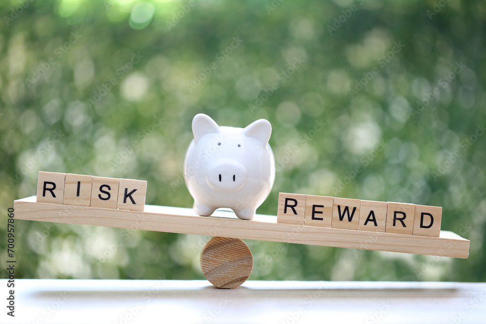 Wording risk and Reward on wood block on natural green background ...