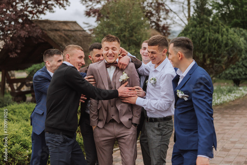 Bild auf Leinwand Cheerful, young, energetic witnesses of the groom next to the groom