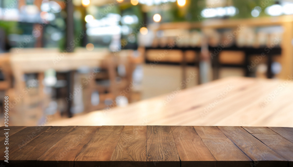Wooden board empty table in front of blurred restaurant or coffee shop background. can be used for display or montage your products. Mock-up for display of product.