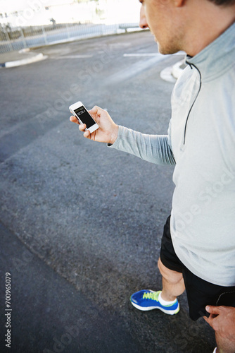 Man, runner and checking phone for progress, screen and exercise or training for marathon. Male person, athlete and workout by city background, mobile app and performance challenge or timer on road