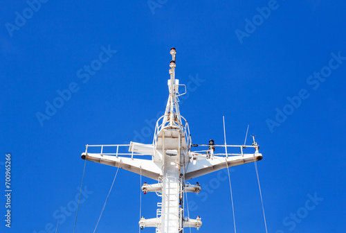 Mast of a cargo ship with navigation equipment bottom view. Radar, signal beeps and signal lights.