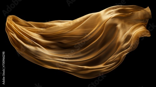 Gold cloth that is floating and hiding something unknown underneath. Fabric isolated on black background.  photo