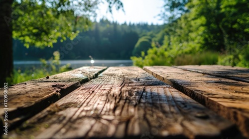 A close up view of a wooden table positioned near a serene body of water. This image can be used to depict a peaceful outdoor setting or a scenic waterfront location
