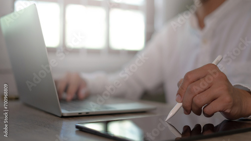 Businessman background at a desk using a tablet in close-up