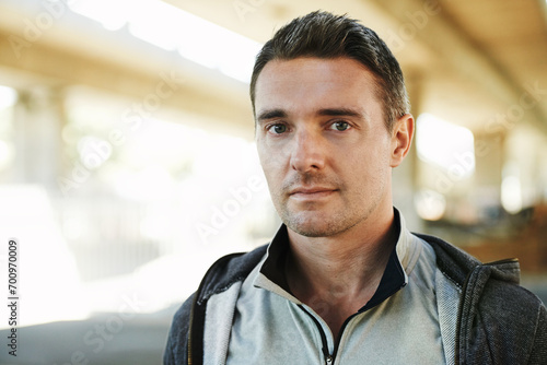 Man, portrait and fitness in city street for running, exercise or outdoor training in fitness. Closeup of male person or athlete ready for workout, cardio or health and wellness in an urban town